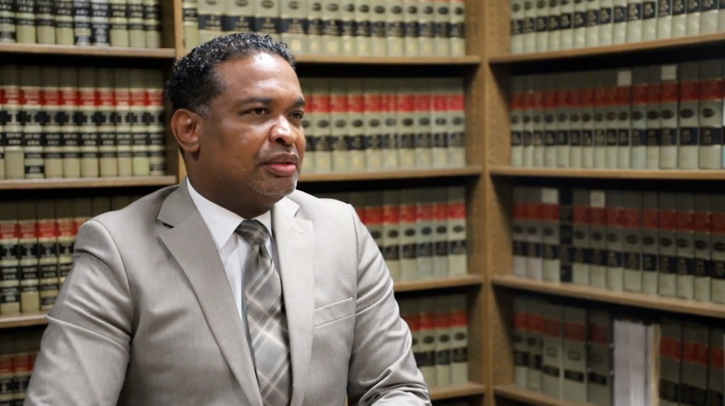 Attorney in the law library. Play the internship program video.